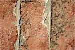 Three red bricks aligned. Old broken red clay tiles with mortar