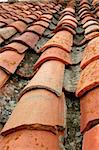Aged old red clay arabic roof tiles, traditional architecture roofing in Spain