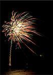 colorful fireworks display with reflection in water