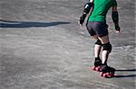 young girl skating leasurely on grey asphalt