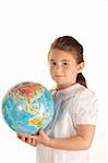 School girl holding a globe