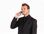 Attractive serious young businessman talking on phone