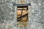 Stone wall and window detail. Abandoned house exterior.