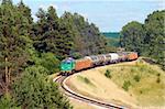 Freight train hauled by the diesel locomotive is passing its route