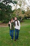 Young couple in an autumn forest picnic area