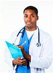 Serious Afro-American doctor holding a clipboard and looking at the camera