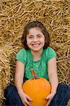 Girl Laughing Holding a Pumpkin