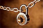 A Chain locked by a lock on brown background