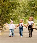 Three young friends go for a walk the park