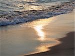 evening sea sandy shore with sunlight path