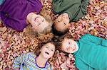 Four Girls Playing in Fall Leaves
