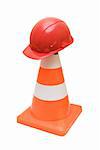 Road warning cone and red helmet isolated on a white background