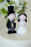 Bride and groom figurines on top of a wedding cake