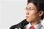 Close up portrait of young Asian businessman looking away