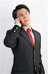 A young Asian businessman talking on his cell phone