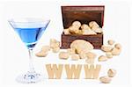 Wealth concept using a glass of coktail and treasure chest with golden nuggets on background
