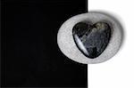 Stone heart on a white stone on a split background