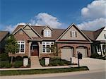 Small home with double garage in a neighborhood where the houses are built close together with very little yard.