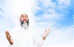 Stock image of Arabic man praying over open sky background