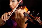 young beautiful female violinist, focus on her fingers