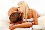 Young couple kissing in bed