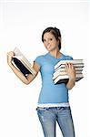 Beautiful Caucasian student with a hand full of books