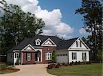 Two story residential home with brick and board siding on the facade.