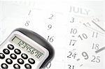 Calculator, clock hands and July calendar