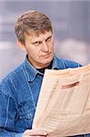 Worried man with the newspaper
