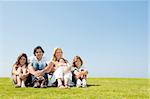 Smiling family of five looking at camera