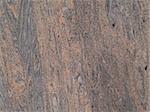 Marbled grained texture with a vertical grain in gray and tan colors.