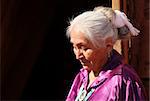 Elderly Navajo Woman Looking Down Outdoors in Bright Sun