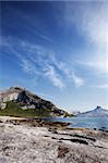 A coastal landscape in northern norway with a mountain and rock