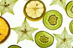 Fruit background: slices carambola, orange and kiwi