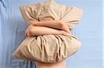 Boy Hugging Pillow in Bed