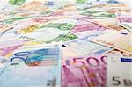 Lots of euro banknotes scattered over the table - side view, shallow depth of field