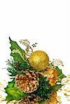 Christmas decoration - green and gold branch with pine cone, baubles, leaves and other ornaments