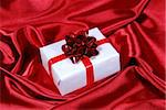 red gift box on red satin background