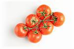 Six fresh tomatos on white background