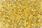 Background of yellow omega-3 oil capsules