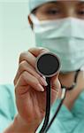 Female doctor with stethoscope in an emergency room lighting environment.Selective focus on the stethoscope.