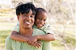 Happy African American Woman and Child Having Fun in the Park.