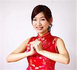 Oriental girl with traditional Cheongsam suit wishing you a happy Chinese New Year.