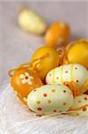 Little yellow Easter eggs on white background. Shallow dof