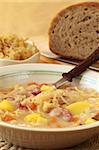 Czech cabbage soup made from sauerkraut with potato, carrot and meat sausage