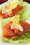 Appetizers with smoked salmon, lettuce and lime