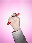 A scientist holds a test tube on his fist.