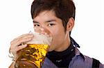 Closeup of handsome young man drinking beer out of beer stein. Isolated on white.