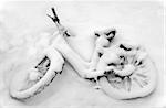Abandoned kids bike covered in snow