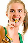 blond woman licking candy on white background